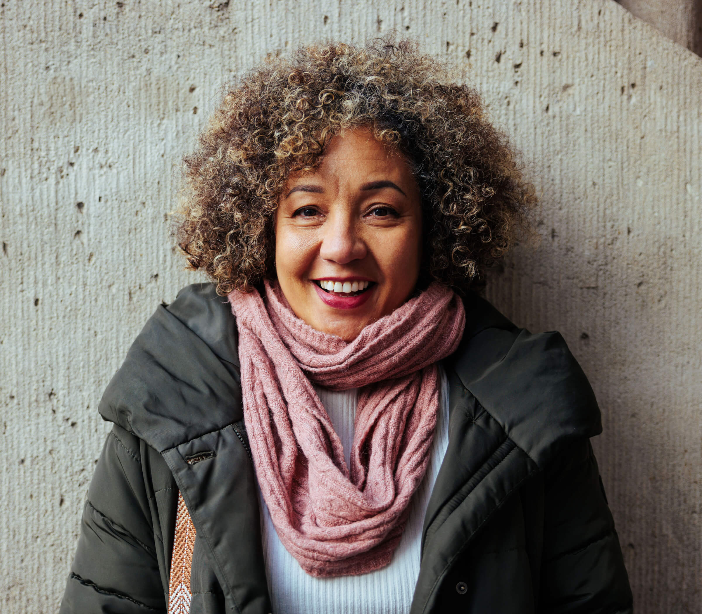 Photo of a woman wearing a pink wool scarf