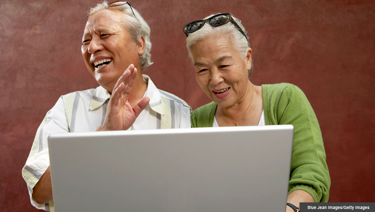 Senior couple communicates through social media on the computer