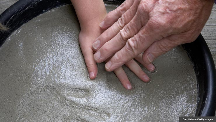 8 Cool Science Activities to do with Grandkids- a grandfather presses his grandchild's hands into cement to make prints 	