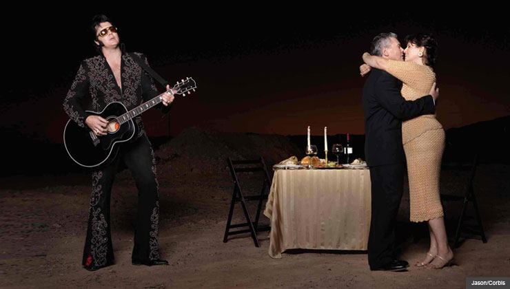 Couple embracing at a candlelight dinner with a crooner - innovative and inexpensive ways to express affection
