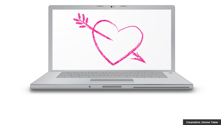 Laptop computer screen with drawn love heart and arrow