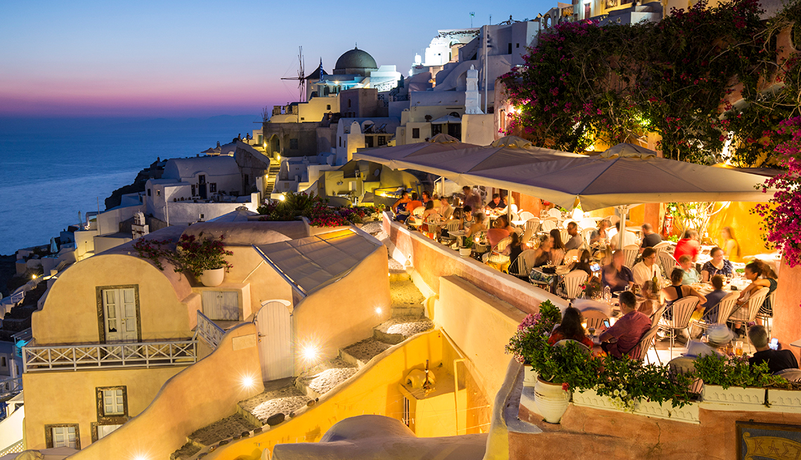 Crowded restaurant, dusk, Santorini, Cyclades Islands, Greece, AARP Research, Life, Leisure