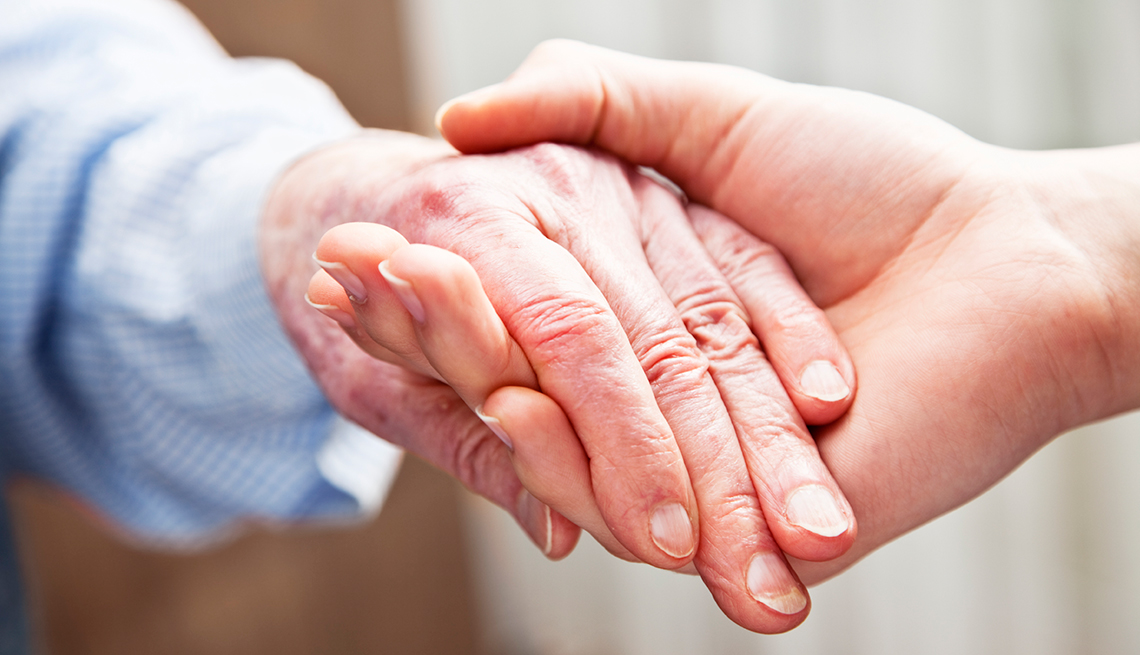 Mature woman, caretaker, holding hands, longterm care, AARP Research, Topics and Issues