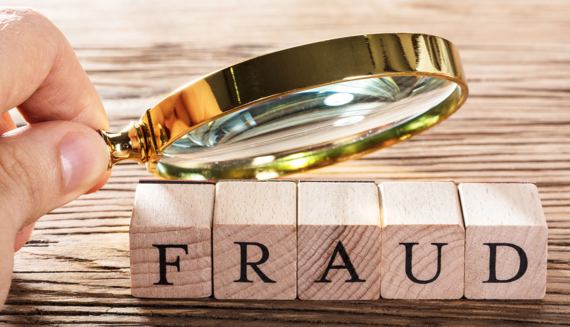 Magnifing glass on the word "fraud"