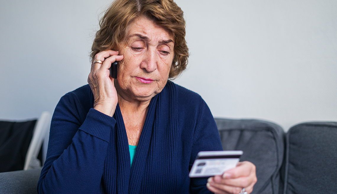 Mature Woman on Phone Holding Plastic Card