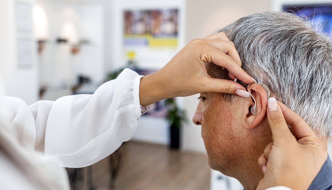 Older White Man Being Fitted for Hearing Aid