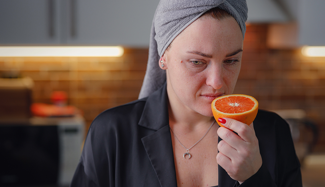 Woman Trying to Smell a Cut Orange
