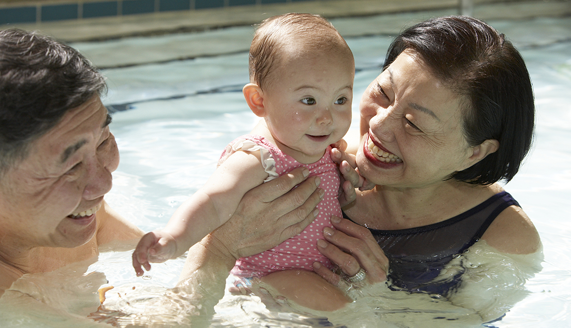 Asian Grandparents Swimming With Grandchild