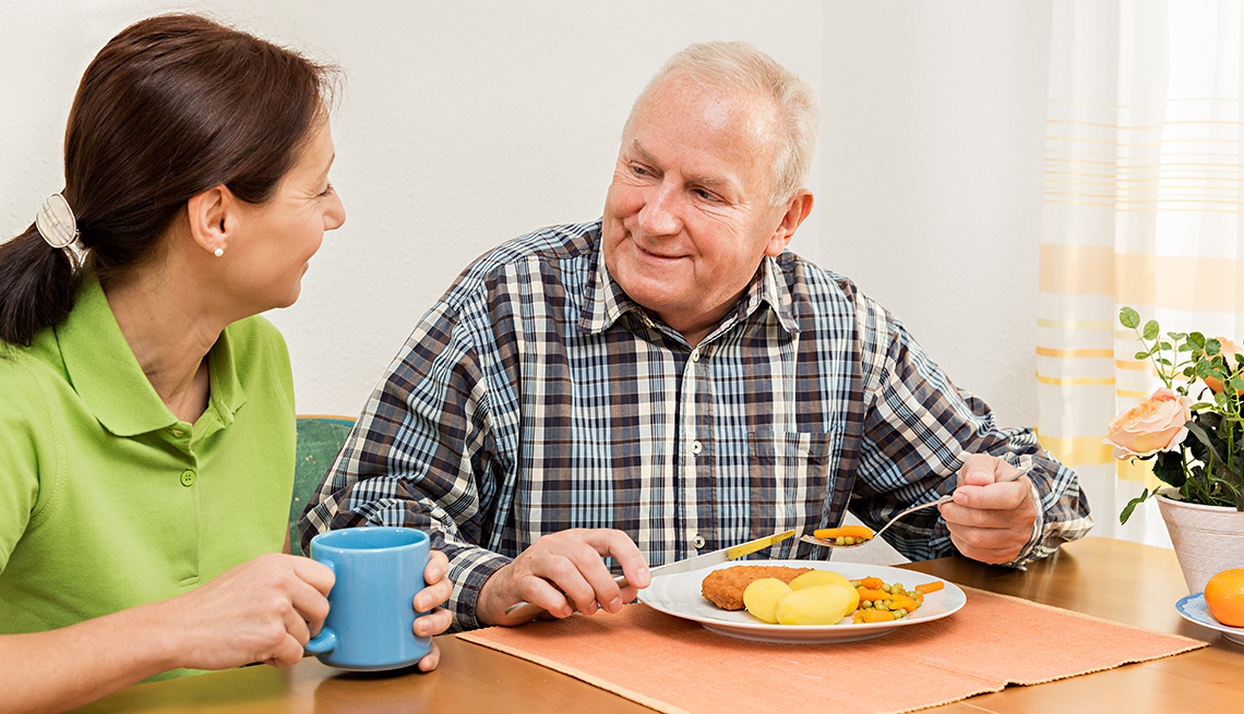 Caregiver with Mature Man Eating a Meal, AARP Family Caregiver Survey, Holiday Stressors and Emotions