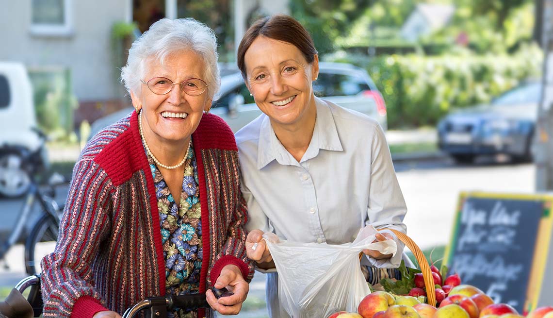senior woman shopping with caregiver