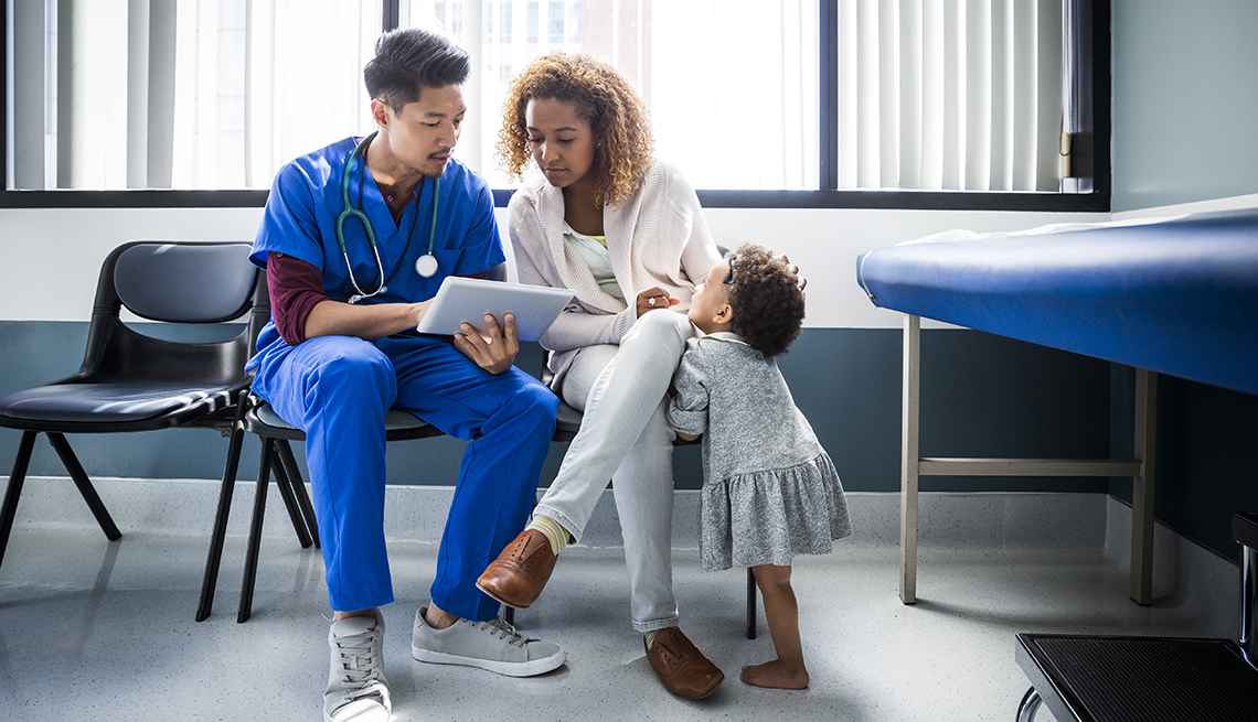 Nurse consulting with mother and daughter