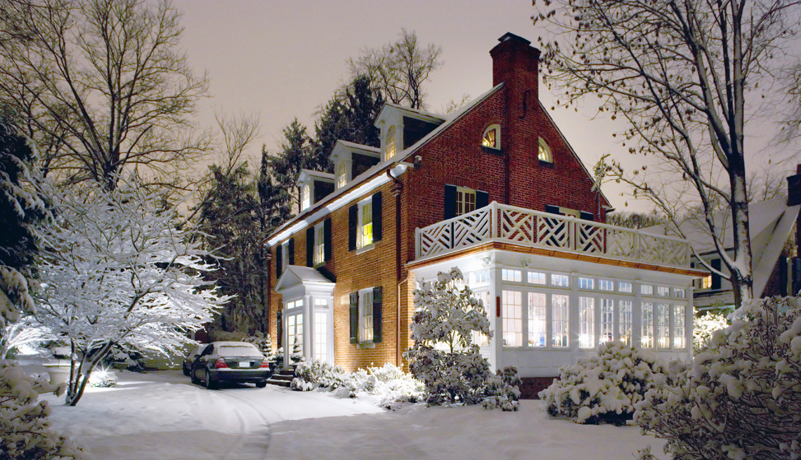 a colonial house on a snowy night