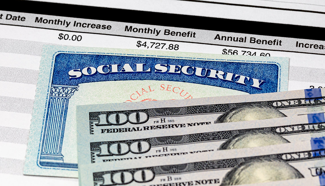 close up of  a Social Security Card, benefits statement and 100 dollar bills