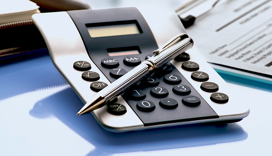 Calculator with a pen to represent AARP's Social Security calculator