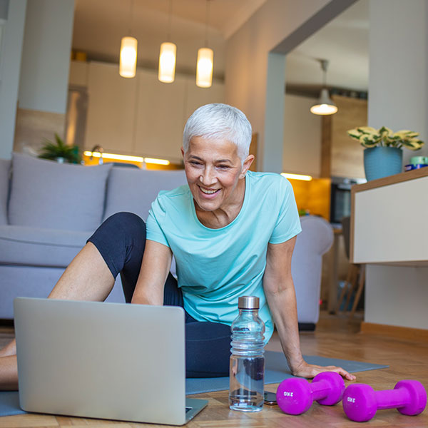 Woman selects workout videos on computer
