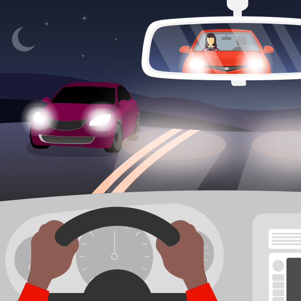 Person driving car at night seeing oncoming headlights 