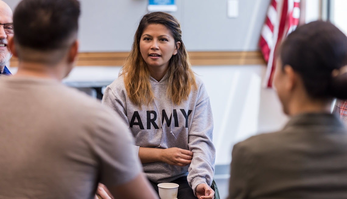 Woman veteran talking with others in a classroom