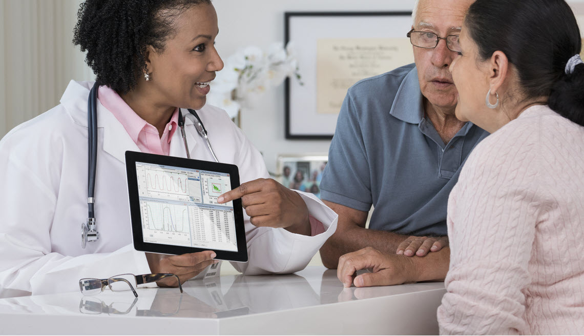 Veteran couple discussing health issues with doctor
