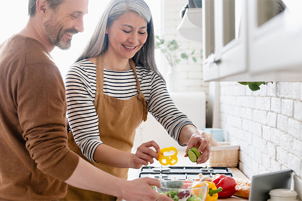 Couple making dinner in kitchen 