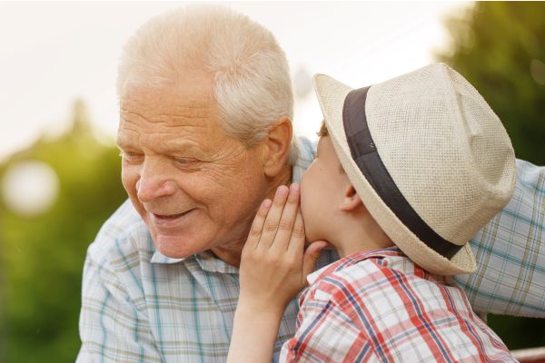 Young Boy Talking to Smiling Elderly Man