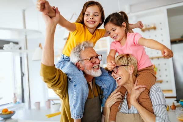 Grandparents smiling with their grandchildren