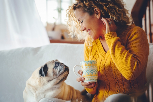 Lady drinking coffee with dog