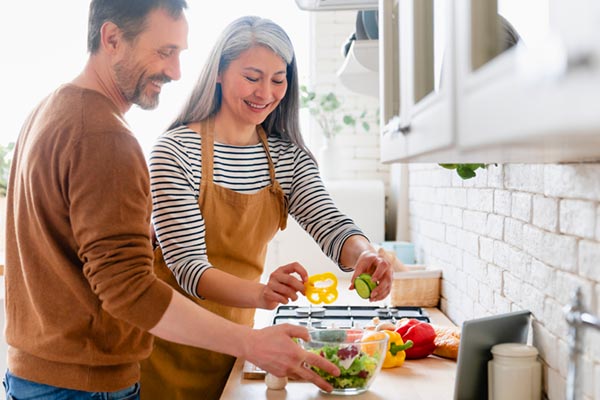 Man and woman making a salad