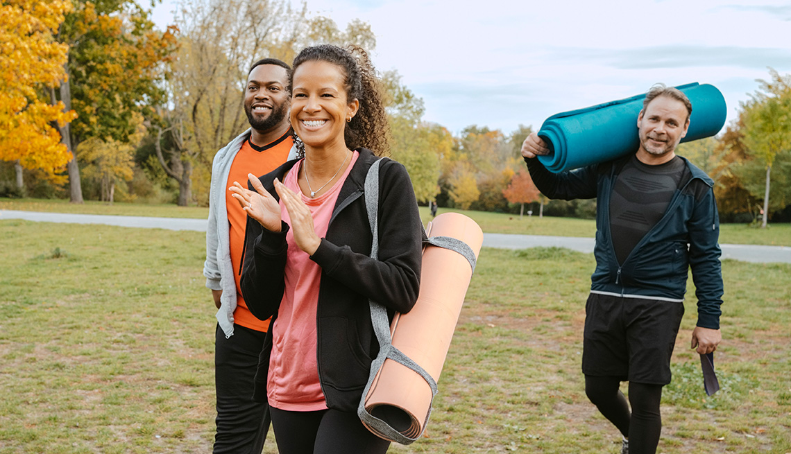 Group of A A R P members walking up to an outdoor group fitness class in the park on a fall day