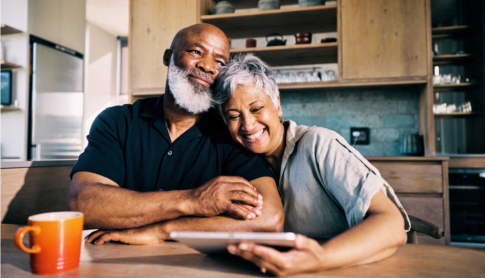 couple holding tablet smiling