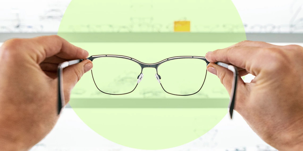 Person holding eyeglasses.