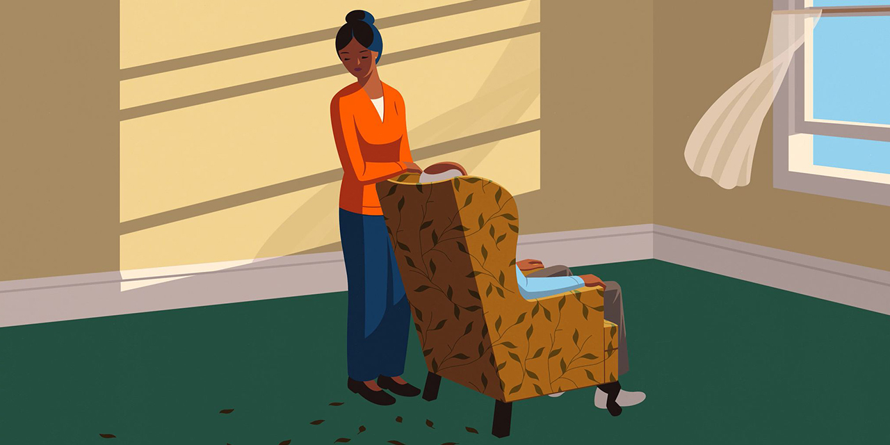 Person standing beside a loved one who’s sitting in a chair.