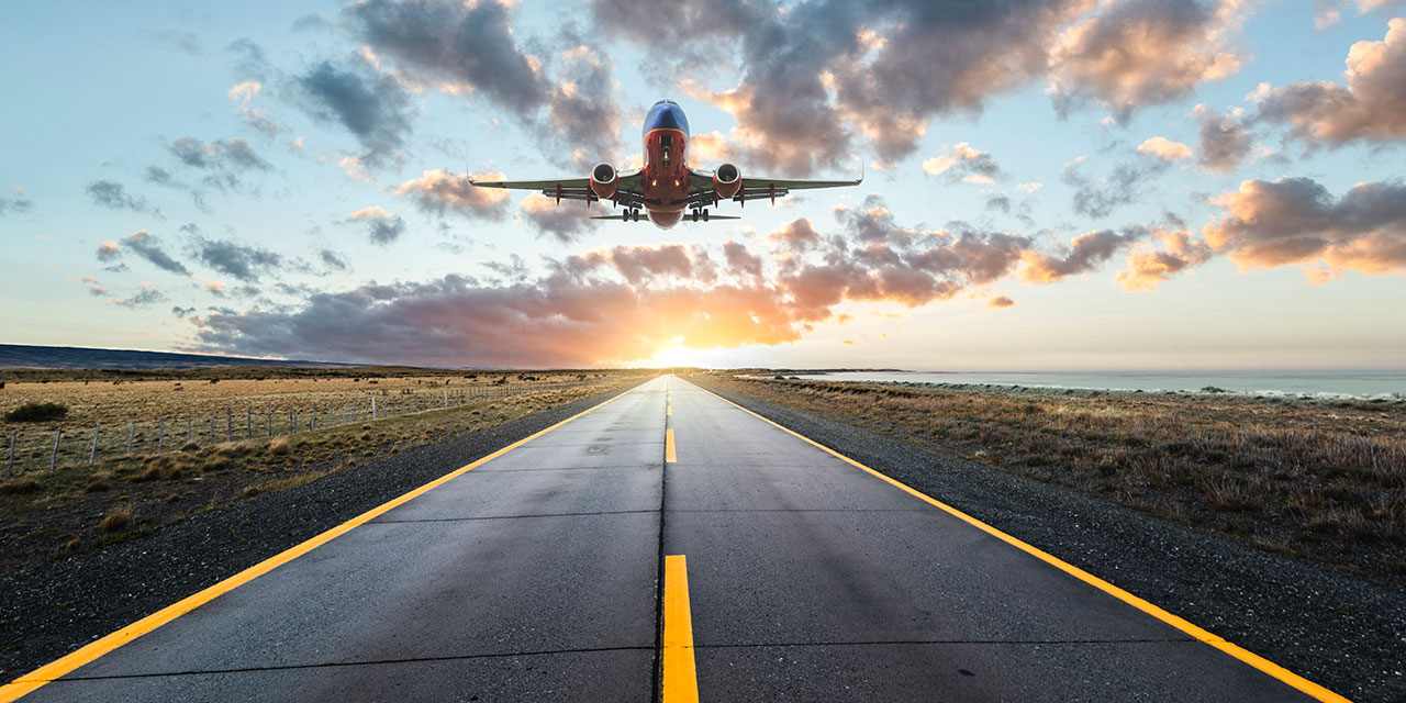 Plane landing at sunset