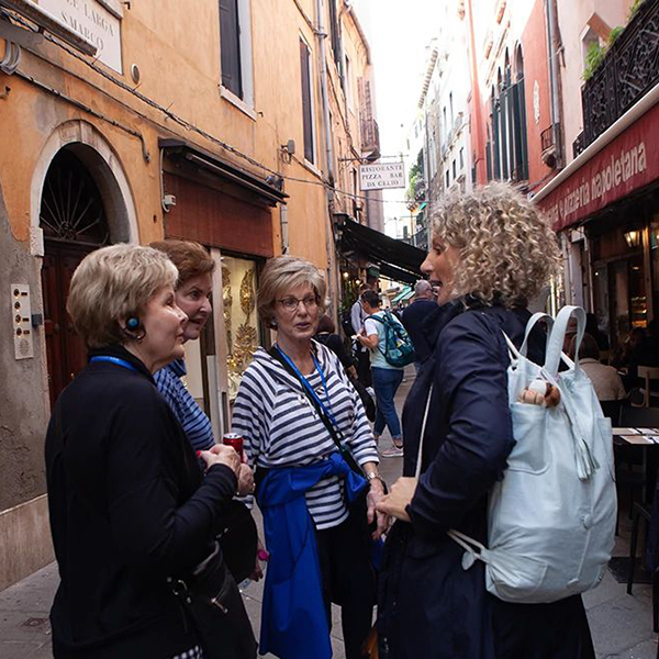 Friends stop to chat while exploring new city.