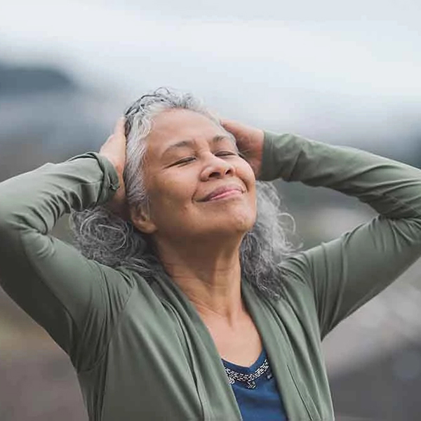 smiling woman with curly gray hair 