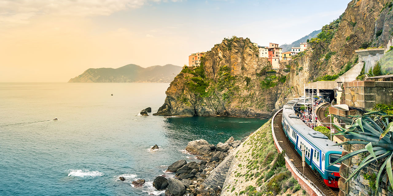 Manarola, Cinque Terre - train station in small village with colorful houses on cliff overlooking sea. 
