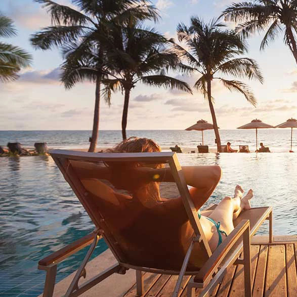 600x600-man-woman-lounging-pool-side-hotel-resort.