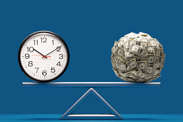 Clock and a ball of money rest evenly on a scale.