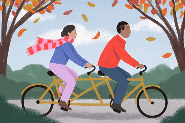 Couple riding a tandem bicycle.