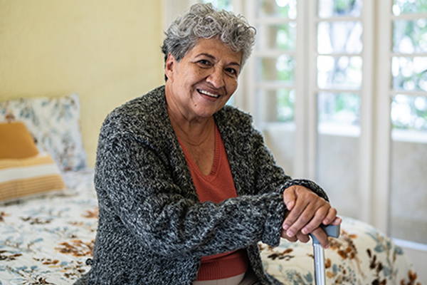 Person sitting on the edge of a bed.