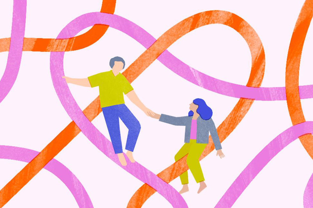 People holding hands among strings forming the shape of a heart.