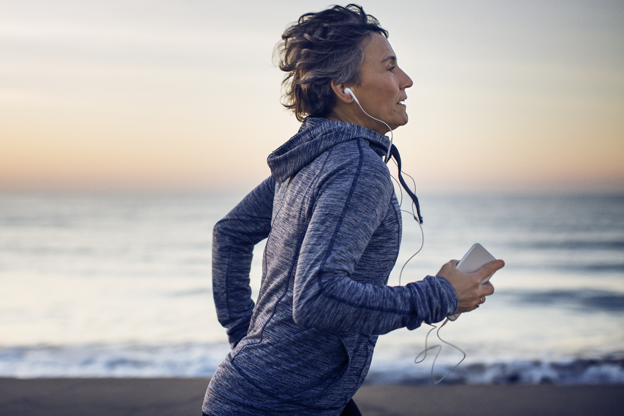 Person jogging on a beach.