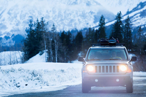 SUV driving in snowy conditions.