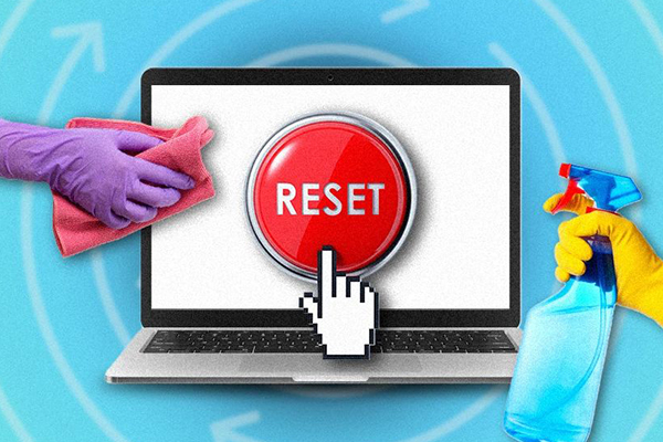 Laptop with a reset button on its screen.