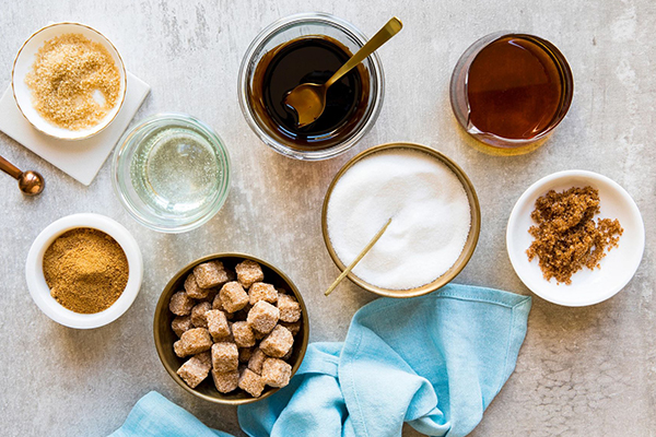 Various sugars and sweeteners in bowls.