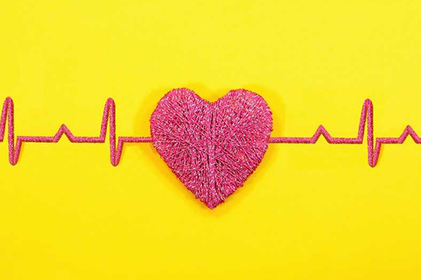 An EKG and heart made of yarn.