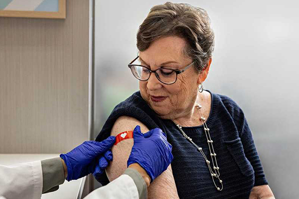 Person receiving a bandage after a vaccination.