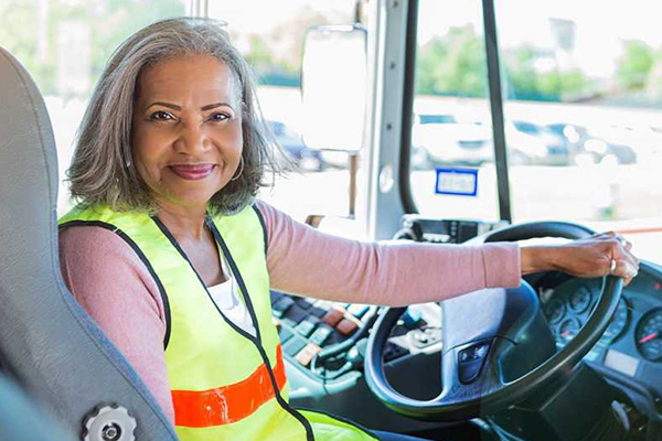 Bus driver posing for a photo.