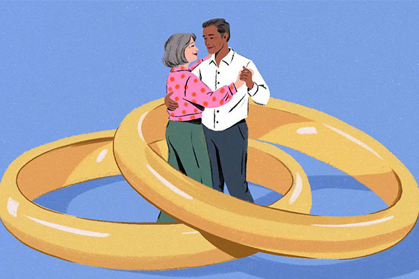 Illustrated couple dances inside linked wedding bands.