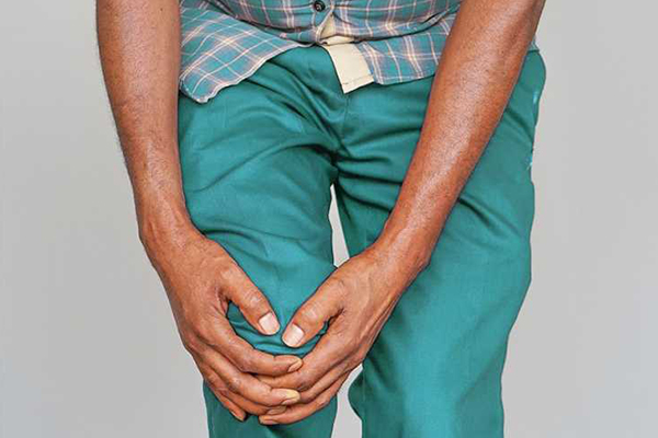 Person holding their knee.