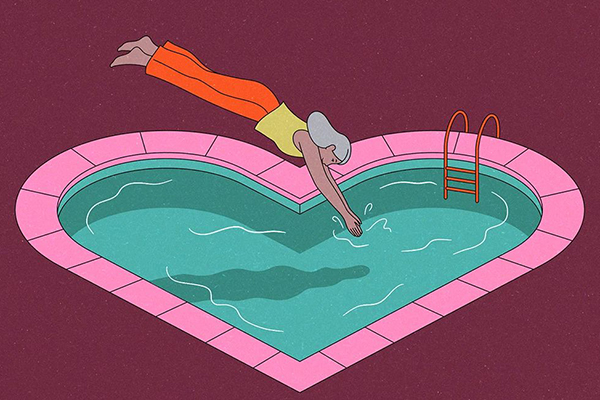 Person diving into a heart-shaped pool.